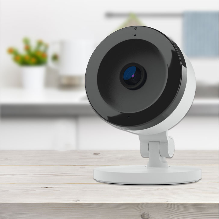 small, round camera sitting on a kitchen counter